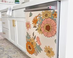 an image of a kitchen setting with flowers on the refrigerator door and tile flooring