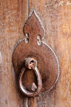 an old door handle on a wooden door