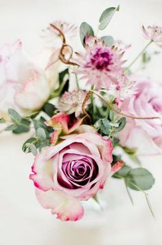 pink and white flowers are in a vase