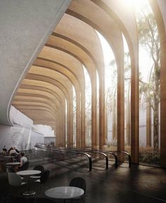 an empty room with tables and chairs in the center, surrounded by tall wooden arches