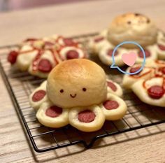 there are many small pastries on a cooling rack with a smiley face in the middle