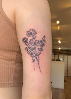 a woman with a flower tattoo on her arm