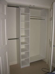 an empty closet with white shelves and open doors