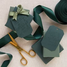 green ribbon, scissors and tags with happy birthday wishes on them sitting next to each other