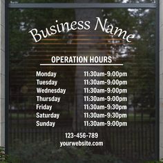 a business hours sign in front of a window