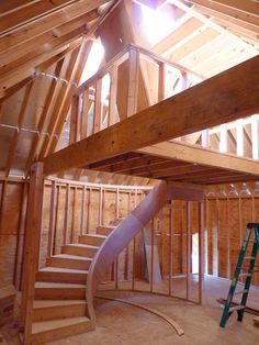 an unfinished house with wooden walls and stairs leading up to the second floor, which is being built