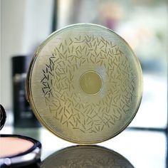 a round mirror sitting on top of a table