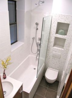 a bathroom with a sink, toilet and bathtub next to a window in it