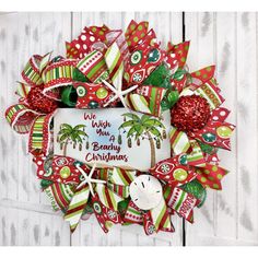 a red and green christmas wreath with palm trees