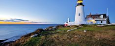 a lighthouse on top of a hill near the ocean