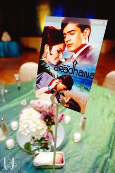 a table with a sign and flowers on it that says, aradhhanana