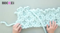 someone is crocheting the yarn on top of each other to make a blanket