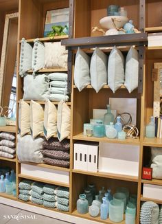 the shelves are filled with towels and other items