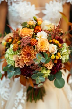 a bride holding a bouquet of flowers in her hands