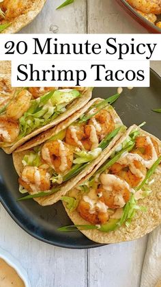 two shrimp tacos are on a plate with sauces and garnishes