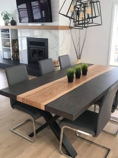 a dining room table with chairs and a fireplace in the backgroung area