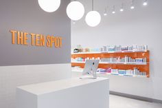 the front desk of a store with bottles on it and lights hanging from the ceiling