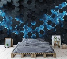 a bed sitting in front of a wall covered in blue hexagonal tiles on it