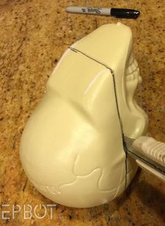 a close up of a toothbrush holder on a counter with a pen and scissors