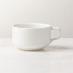 a white cup sitting on top of a table