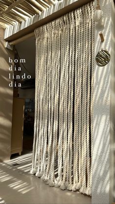 a white curtain hanging from the side of a building