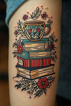 a tattoo with books and a cup on it