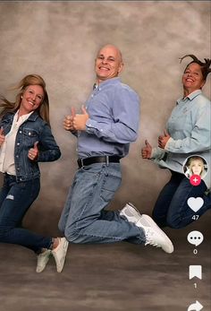 two women and a man are jumping in the air with their thumbs up while smiling