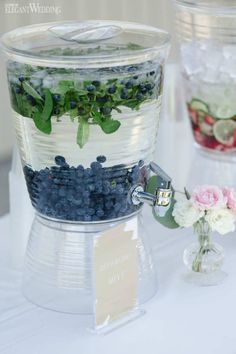 blueberries, strawberries and other berries are arranged in clear containers on a table