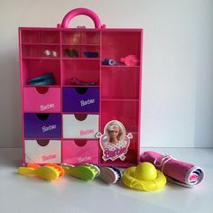 a pink barbie doll's storage unit with shoes and accessories