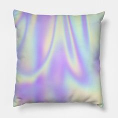 a pillow that is sitting on top of a white wall with a blurry background