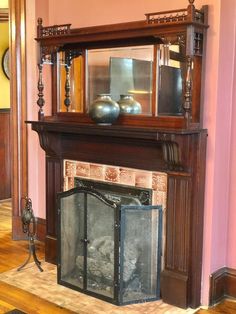 an old fireplace with a mirror above it