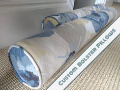 a rolled up rug sitting on top of a floor next to a sign that says curtain posts pillow