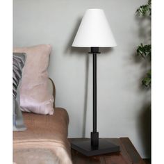 a lamp sitting on top of a table next to a couch