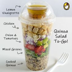 a plastic container filled with salad ingredients and labeled on the side, sitting next to a fork