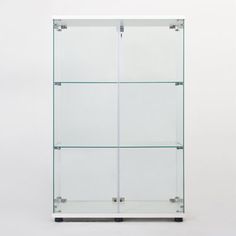 an empty glass display case against a white background