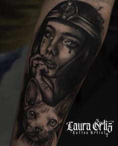 a woman with a cat on her arm is shown in this black and grey tattoo