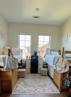 a room filled with lots of wooden furniture and bunk beds next to two large windows