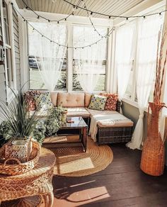 a sun room with wicker furniture and plants