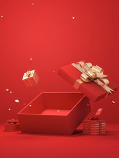 two red boxes with gold bows and confetti falling from them on a red background