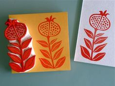 two paper cuttings with pomegranate designs on them