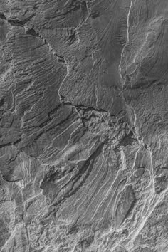 an aerial view of the surface of a large rock formation, with lines in it