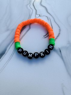 PUMPKIN Halloween Beaded Bracelet | Kids Bracelet | Heishi Bracelet | Gift for Kids | Halloween Accessories | Gift for Boys | PUMPKIN Themed Add a playful touch to your Halloween style with this super fun pumpkin inspired clay beaded bracelet! Featuring orange and green pumpkin inspired design and a cute 'PUMPKIN' letter detail, this stretchy bracelet is perfect for Halloween trick or treating or adding a bold accent to any outfit. Handmade with high-quality polymer beads, it's comfortable and l Clay Bead Patterns Bracelet, Halloween Bracelet Ideas Clay, Halloween Clay Bead Bracelet Ideas, Bracelet Ideas For Boys, Bracelet Heishi, Kids Bracelet, Heishi Bracelet