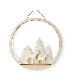 a wooden ornament with two deers and trees in the woods on a white background