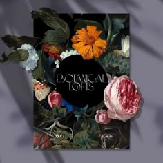 a book cover with flowers and leaves on it, in front of a black background