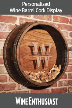 a wine barrel sitting on top of a brick wall next to a bunch of nuts