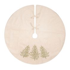 a round table mat with embroidered trees on it