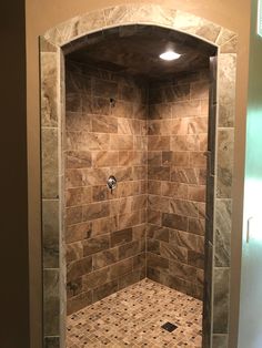 a walk in shower sitting inside of a bathroom