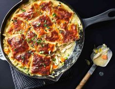 a skillet filled with lasagna covered in sauce