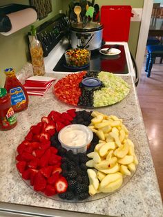 an assortment of fruits and vegetables are arranged on a counter top in the shape of a pie