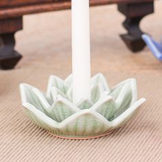 This mesmerizing candle holder intricately fashioned in the likeness of a delicate lotus flower is a splendid addition to your beautifully arranged dinner table. Designed by artisan Penpan in Thailand, this extraordinary accessory embodies the rich heritage of celadon ceramic craftsmanship showcased through its distinctive pale green crackle glaze. A perfect blend of elegance and functionality, it stands ready to gracefully cradle a taper candle, infusing your dining experience with a touch of enchantment. Thailand Gifts, Celadon Ceramics, Green Candle Holders, Fragrance Store, Ceramic Turtle, Flower Candle Holder, Green Candle, Ceramic Candle Holders, Crackle Glaze